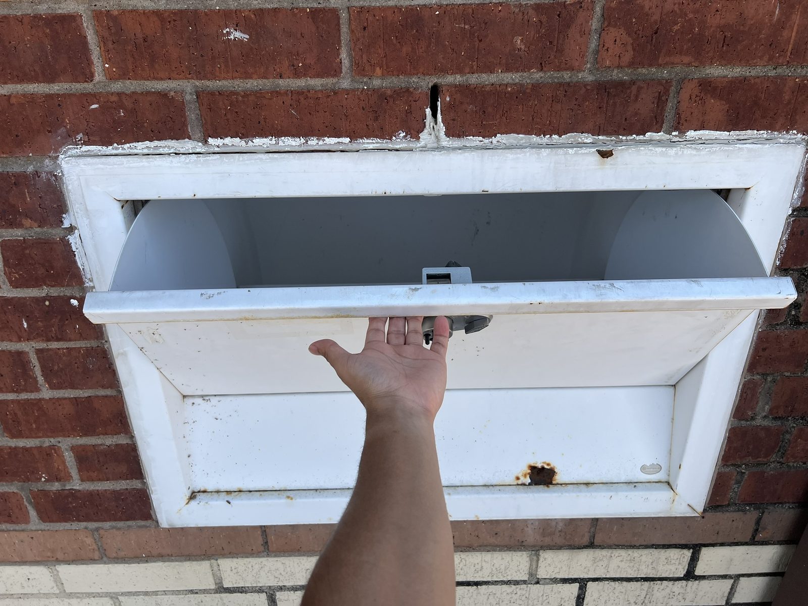 The 24-hour drop-off box pulled open, showing the chute inside